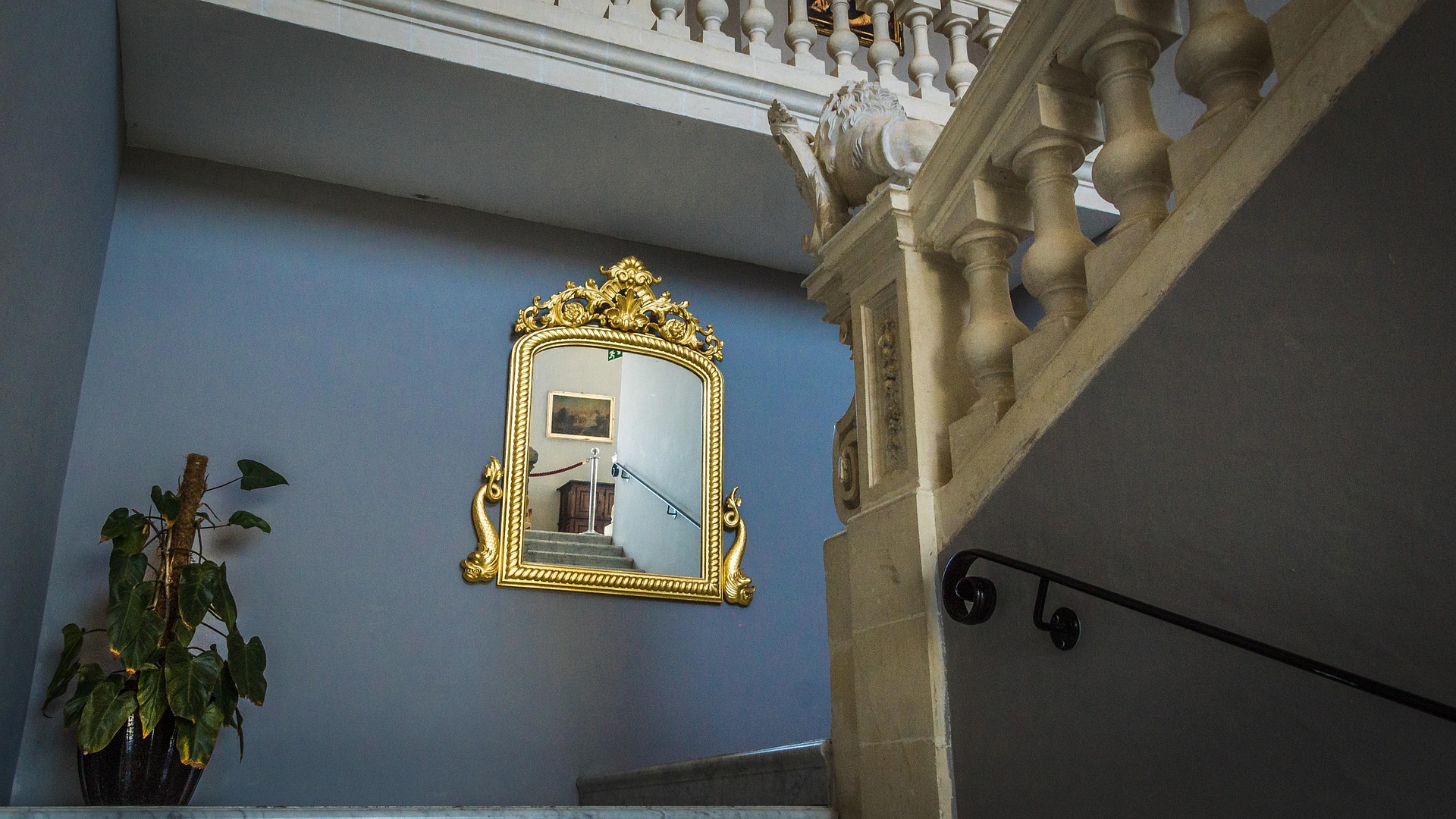 Decorate Staircase Walls With Staggered Mirrors