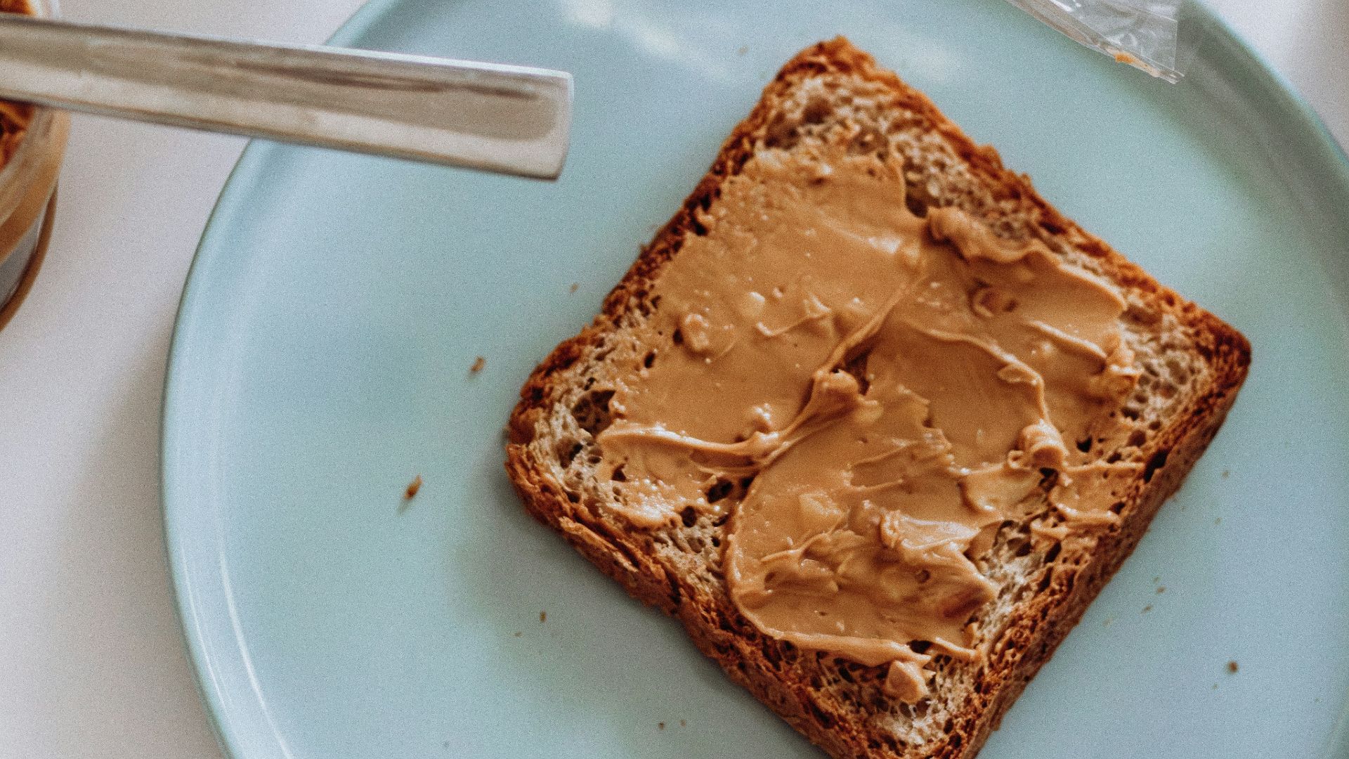 20. Du beurre de cacahuète sur une demi-tranche de pain complet grillé