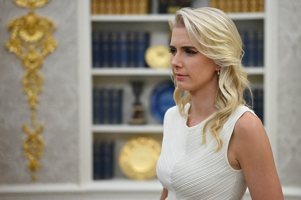 Who is the young blonde aide following Donald Trump everywhere?