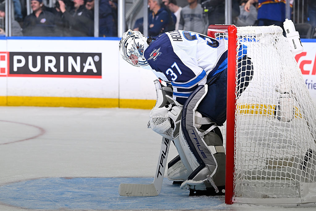 Connor Hellebuyck is expected to miss the start of the Jets’ training camp