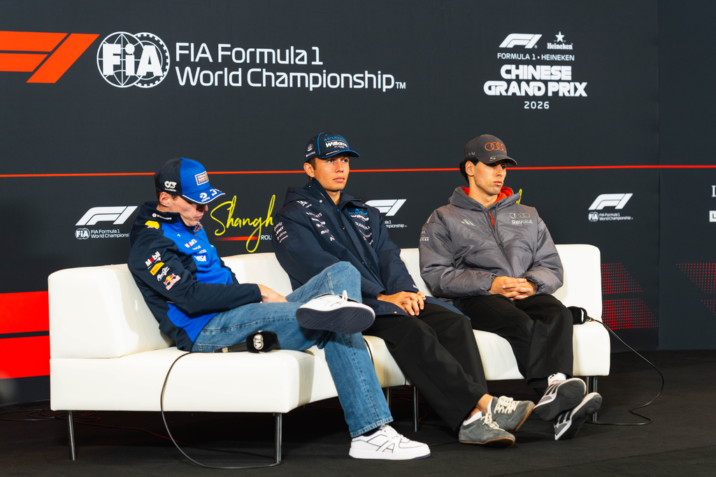 Max Verstappen (Oracle Red Bull Racing), Alexander Albon (Williams), and Gabriel Bortoleto (Audi Revolut) pose during the 2026 Chinese Grand Prix press conference in Shanghai. (Overtake / Levi Erb)